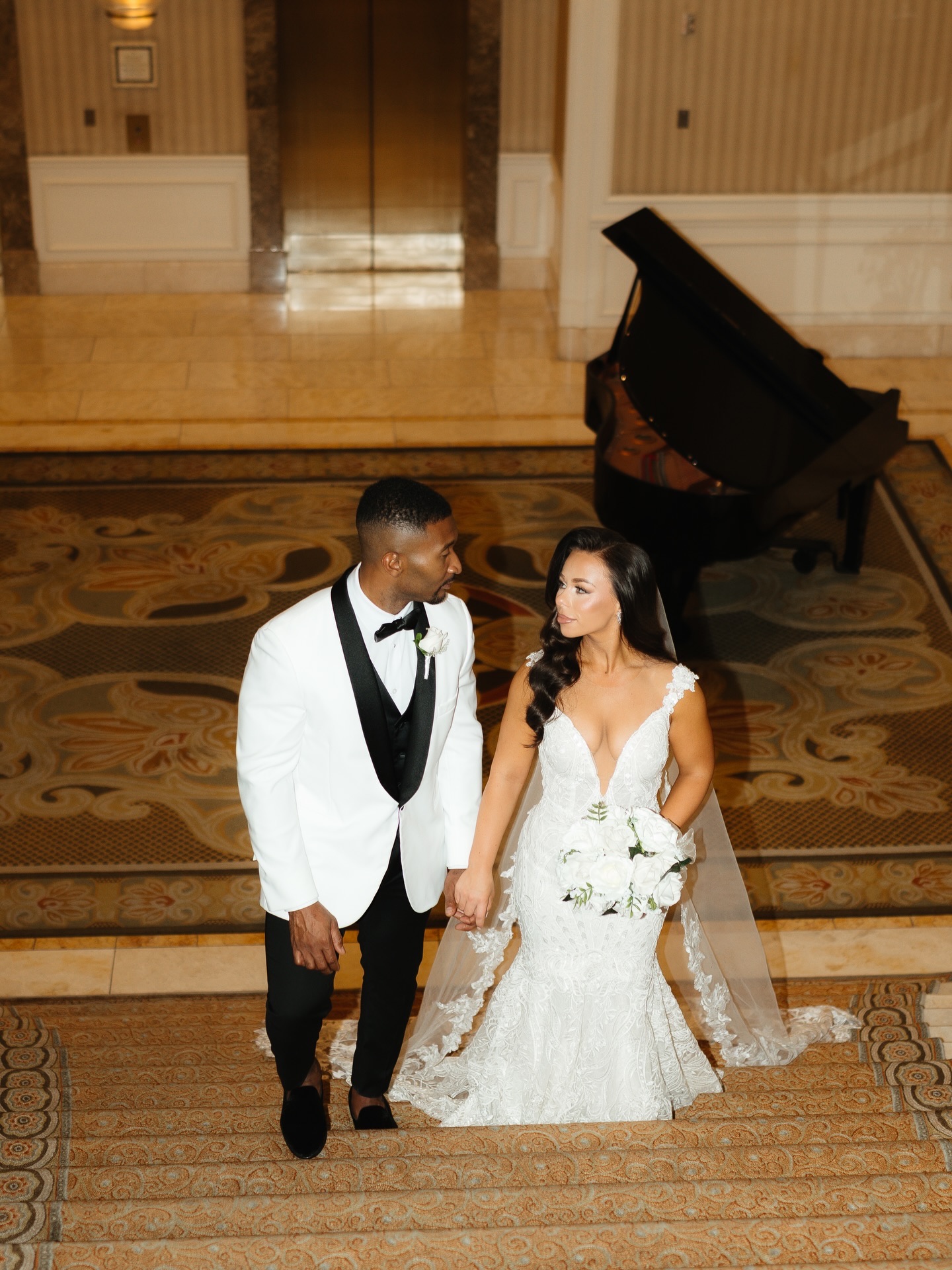 A bride and groom, glowing and camera-ready, in a Las Vegas hotel lobby